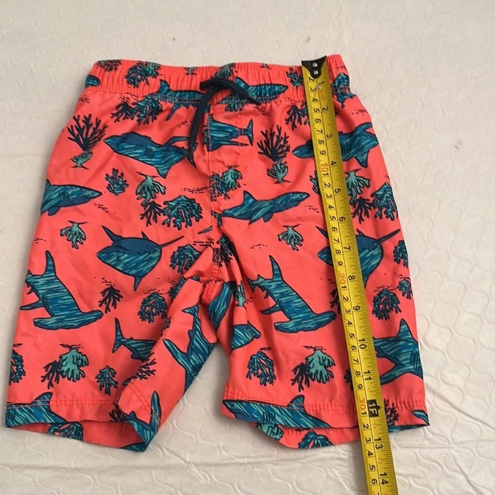 Old Navy coral and teal shark print lined swim trunks